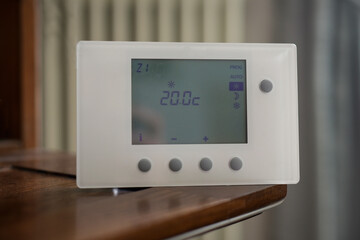 view of a thermostat set with a temperature of twenty degrees