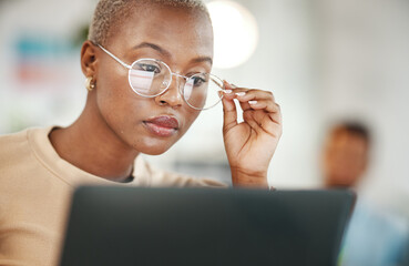 Office, computer and black woman with glasses, serious or reading email, online research or report....