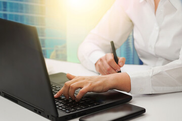 Fototapeta premium Business woman working at the desk in the office. . Social media, business, customer service technology, customer support, assistance; telemarketing, consulting, e-learning concept background.