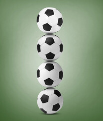 Stack of soccer balls on pale green background