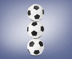 Stack of soccer balls on pale blue background