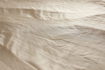 Crumpled dark beige fabric as background, closeup view