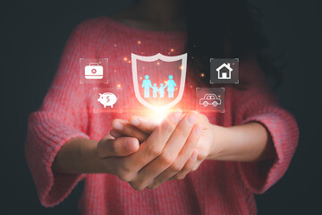 Businesswoman holding insurance icon including family health car, financial and real estate for risk management.