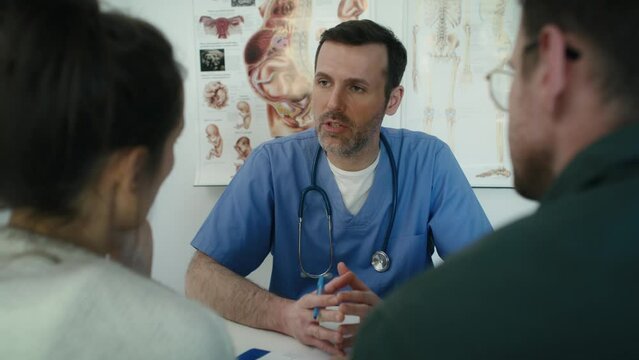Caucasian male doctor explaining prenatal information to a marriage couple. Shot with RED helium camera in 8K. 