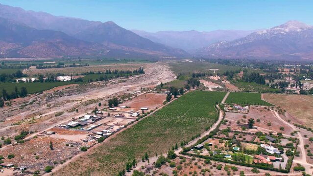 Aerial view establishing an exclusive vineyard in the commune of Pirque, rocky mountains in the background, Santiago, Maipo Valley.