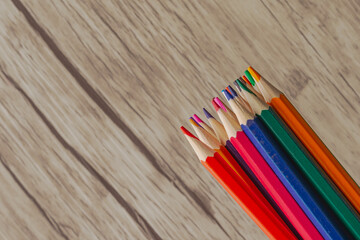 Pencils on a wooden background