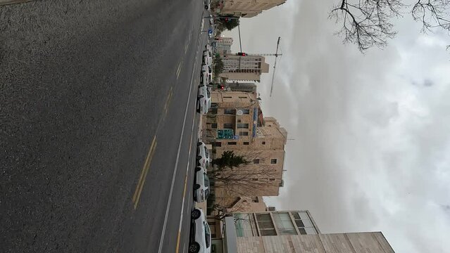  King George Street in downtown Jerusalem, vehicles drive on the road against a cloudy sky