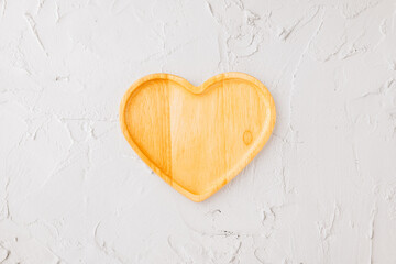 Empty heart shape wooden tray isolated on white cement background, top view, flat lay, dish plate or bowl wood for food, Collection, happy valentine day