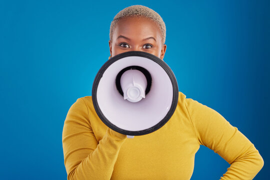 Megaphone, change and speaker with black woman in studio for awareness, democracy and opinion. Vote, announcement and message with female on blue background for empowerment, strike and choice