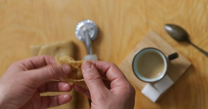 Up close and personal: witness the hands-on artistry as chebakia dough is expertly molded into enticing forms