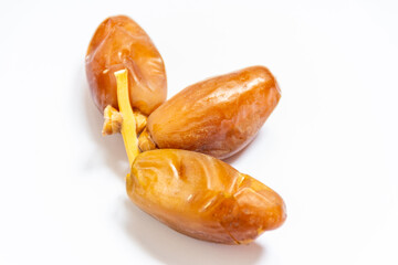 Close-up of Algerian royal dates isolated on white background. Ramadan concept. Delicious fruit.