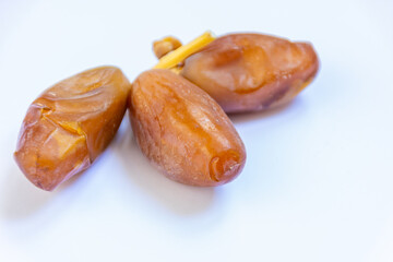 Close-up of Algerian royal dates isolated on white background. Ramadan concept. Delicious fruit.
