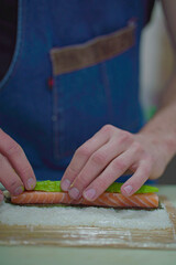 Close up of making a salmon sushi roll