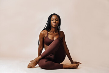 woman in lotus pose yoga studio