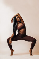 woman squat stretching in studio
