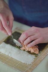 Making pink salmon sushi roll	