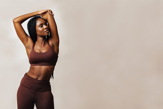 woman stretching arm looking away