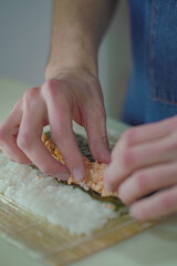 Making pink salmon sushi roll	