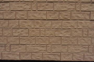 Texture of light brown painted brick veneer wall