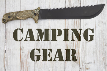 Camping Gear message with a camo machete on wood
