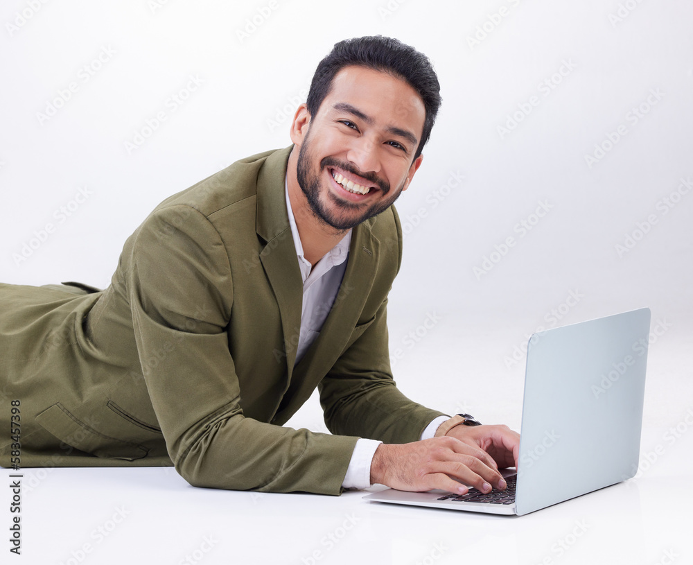 Poster Happy, laptop and portrait of a man in studio relaxing while typing on a keyboard doing research. Happiness, smile and Indian male model with computer working on project isolated by white background.