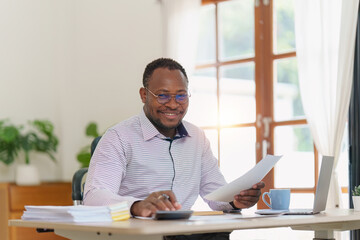 Fototapeta na wymiar Smiling American African makes financial report and studies annual figures, analyzes profits. Accountant checks status of financial