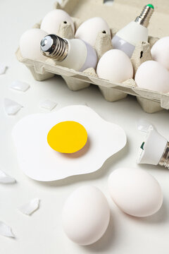 Eggs and bulbs on white background, close up