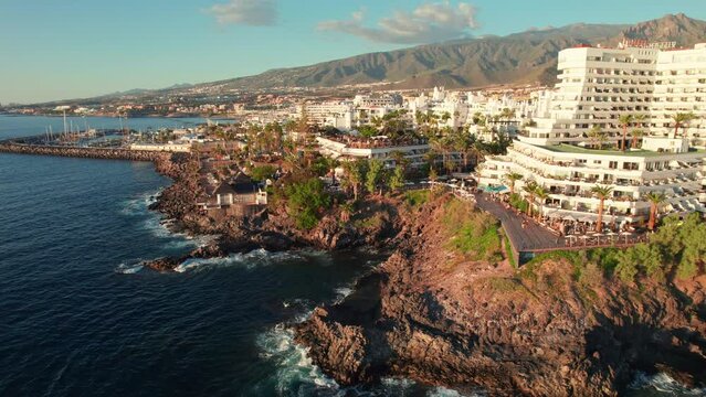 Flight over Costa Adeje resort town at sunset in Tenerife, Canary islands, Spain