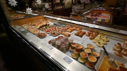 Annecy, France. January 2023. A gastronomy shop window in the historic centre: local culinary specialties on display.