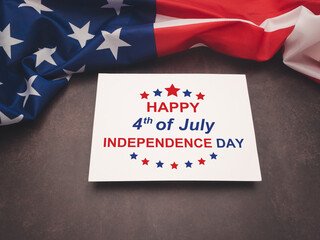 Fototapeta na wymiar American flag and the text of Happy 4th of July Independence day on a white paper over the vintage background