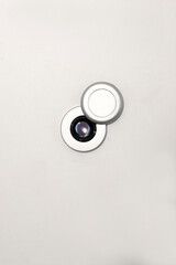 peephole on a white door with copy space for your text