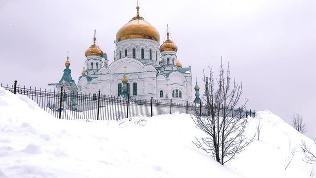 Belogorsky St. Nicholas Orthodox Missionary Monastery. Russia, Perm Krai, Belaya Gora. The temple on the hill in winter. Monastery on the background of snow. 4K