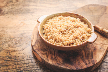 Healthy colorful cooked quinoa. Superfood, gluten-free food on wooden background