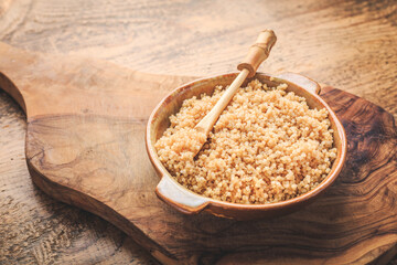 Healthy colorful cooked quinoa. Superfood, gluten-free food on wooden background