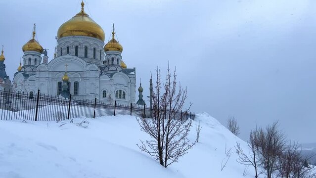 Belogorsky St. Nicholas Orthodox Missionary Monastery. Russia, Perm Krai, Belaya Gora. The temple on the hill in winter. Monastery on the background of snow. 4K
