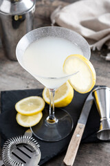 Lemon drop martini cocktail on wooden table. Copy space