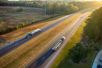 View from above of busy american highway with fast moving trucks and cars. Interstate...