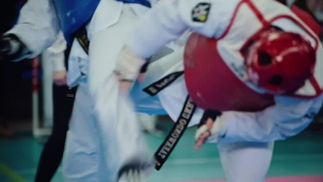 Two sporty men sparring in Taekwondo fittings