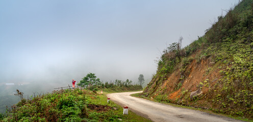 The minorities go to work by motorbike on a foggy forest road in Hang Kia commune, Mai Chau...