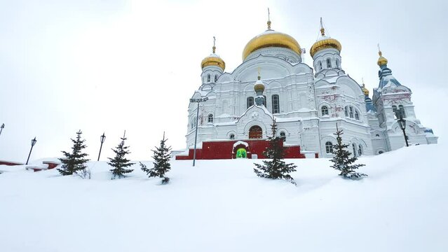 Belogorsky St. Nicholas Orthodox Missionary Monastery. Russia, Perm Krai, Belaya Gora. The temple on the hill in winter. Monastery on the background of snow. 4K