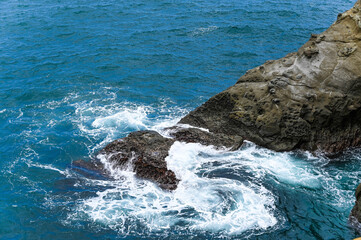 Waves crashing against the rocks..