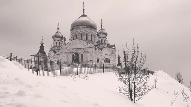 Belogorsky St. Nicholas Orthodox Missionary Monastery. Russia, Perm Krai, Belaya Gora. The temple on the hill in winter. Monastery on the background of snow. 4K