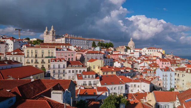 Time-lapse of Lisbon famous view from Miradouro de Santa Luzia tourist viewpoint over Alfama old city district, cruise liner and moving clouds. Lisbon, Portugal. Camera pan