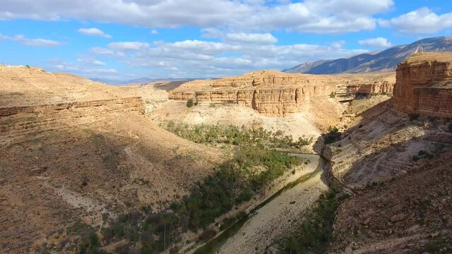 The Ghoufi canyon with the Abio river surrounded by palm trees.