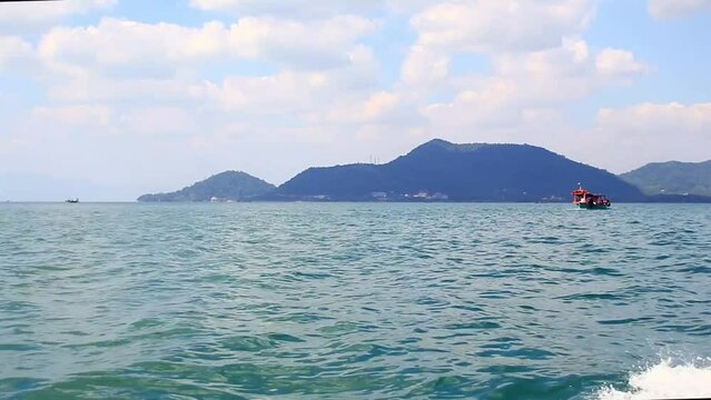 View from a moving speedboat heading to Rabbit Island or Koh Tonsay, a popular summer travel destination in Cambodia