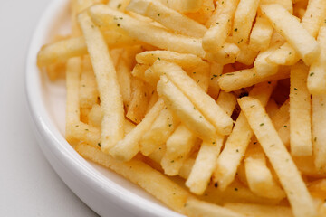French fries background, closeup shot. Delicious potatoes with a golden fried crust. French fries background. Potato straw