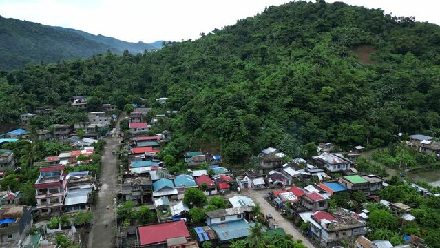 Aerial View of Mountainside Tropical Barangay Village with lush jungle background. Bato, Catanduanes.