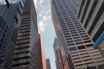 Fototapeta na wymiar View Between Rows of Skyscrapers and Sky