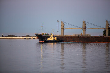 Fototapeta na wymiar bulk carrier vessel is sailing in the port area.