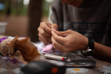 Weaving dreamcatcher on a table in the woods